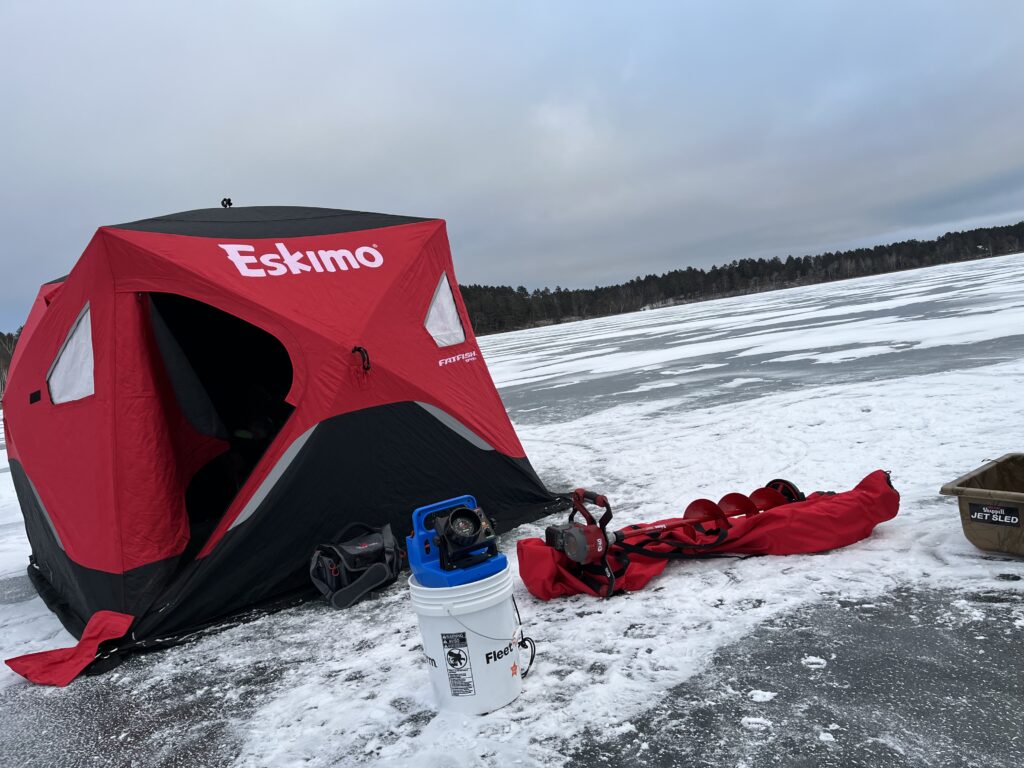 This is a portable Eskimo Brand Ice house that is located for rent near Park Rapids, Minnesota. This photo shows it set up on the ice near Lake Itasca.